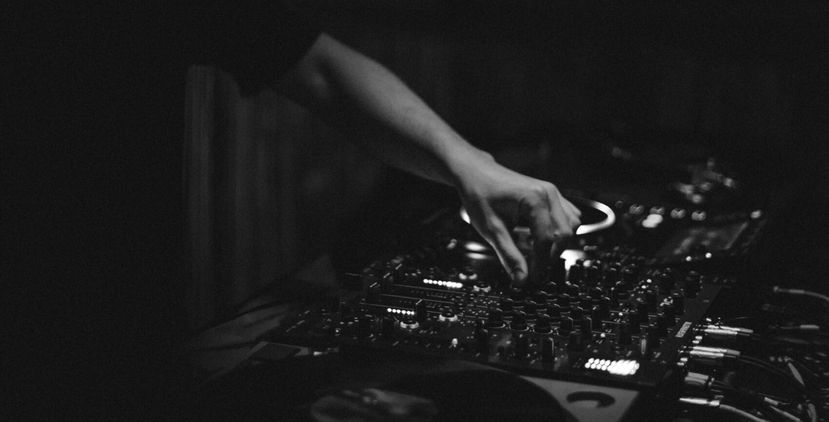 Close up shot of a DJ using the mixer